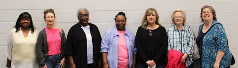 Volunteers give books to kindergarten students