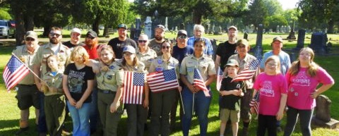 Scouts place flags on veteran’s graves